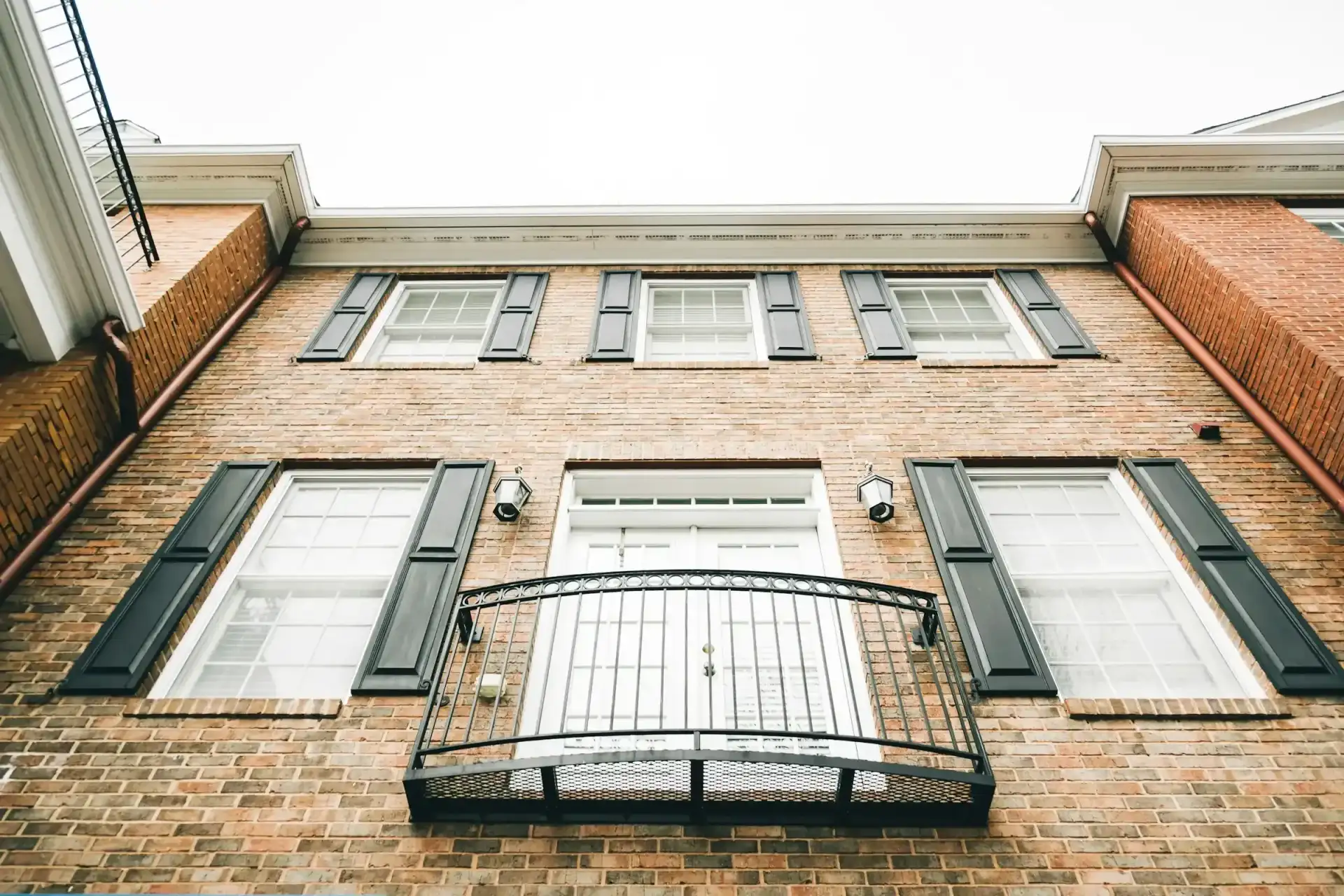 Brick building facade with a balcony