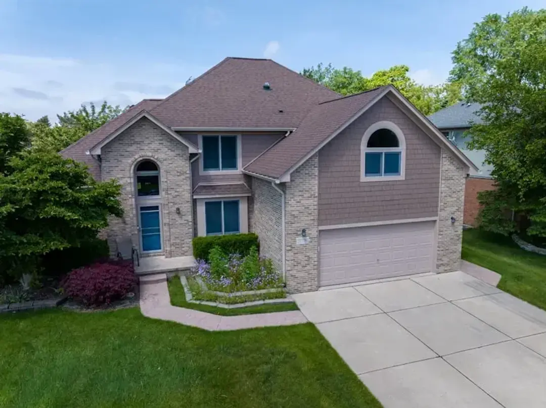 Brick and siding family home with a landscaped yard