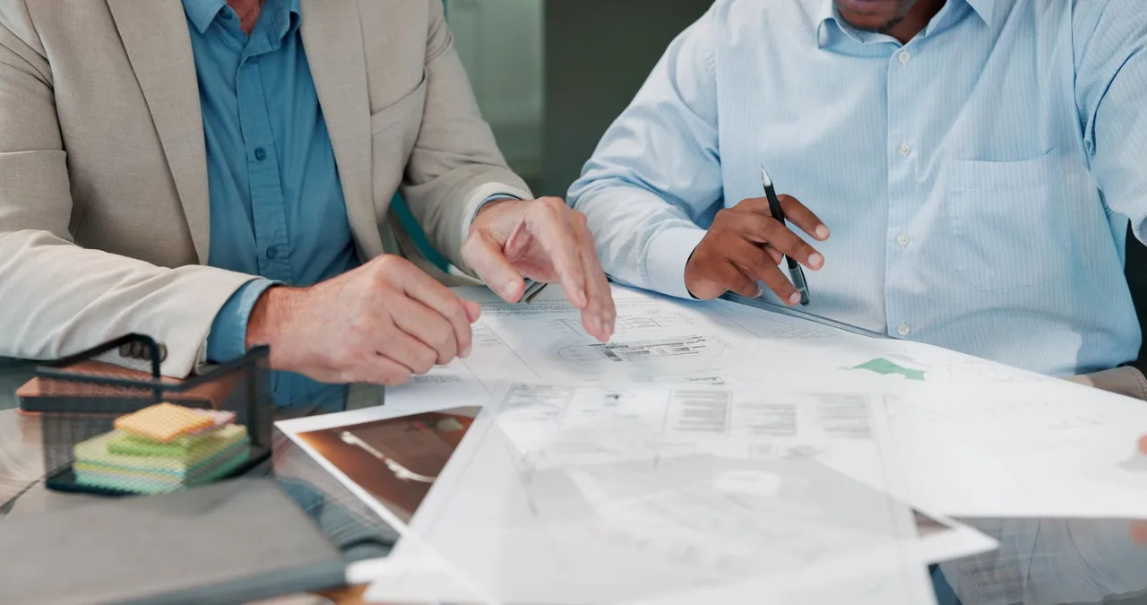 Two people reviewing documents at a desk