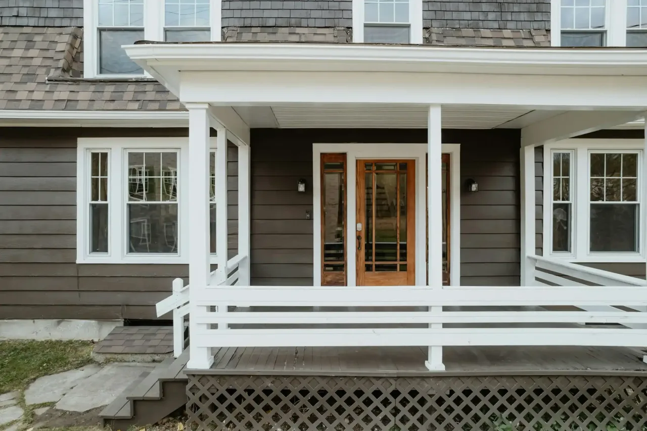 Front porch and entry of a gray shingled house