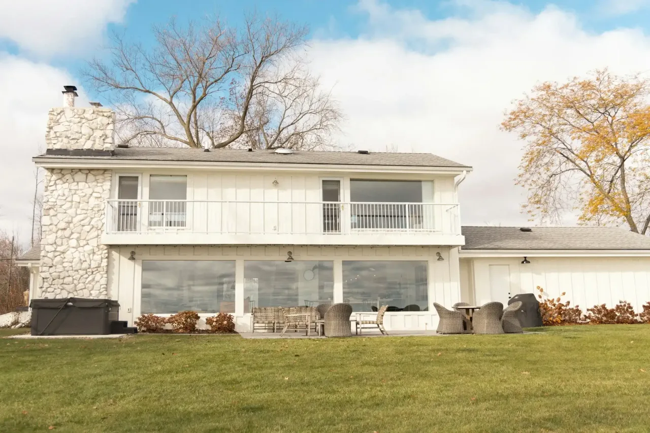 White two-story house with a large lawn