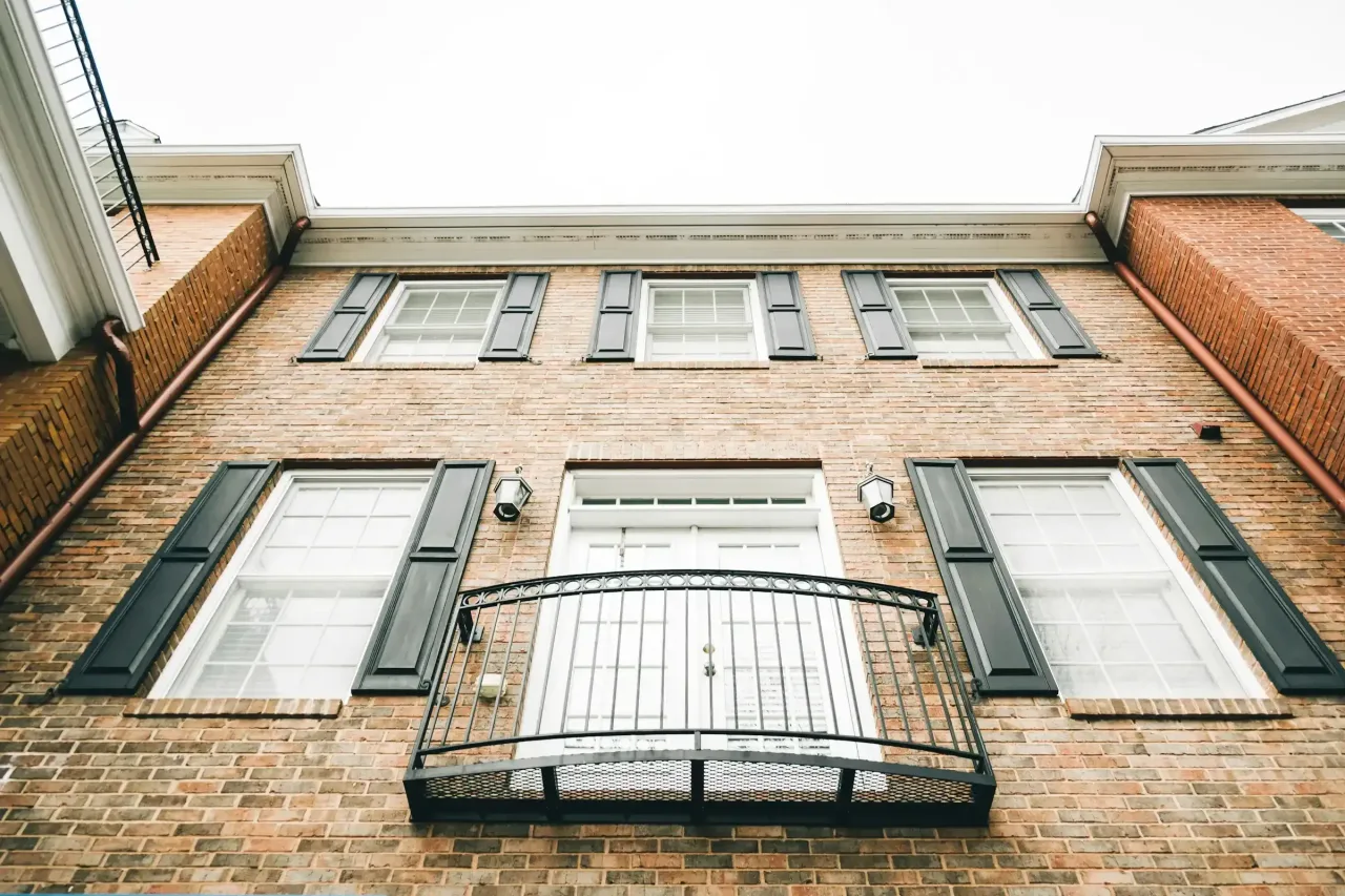 Brick building facade with a balcony