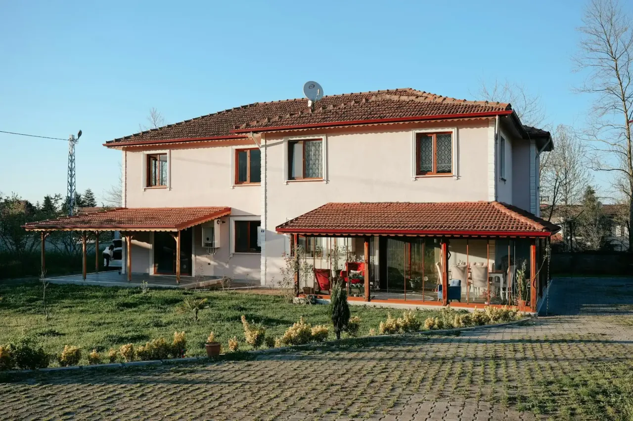 Two-story stucco house with a tile roof